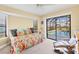 Bright bedroom featuring a cozy daybed, view of a screened pool, and a comfortable reading nook at 3522 Fox Ter, Port Charlotte, FL 33981
