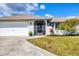 Home with a two-car garage, modern screen door and well maintained lawn at 3522 Fox Ter, Port Charlotte, FL 33981