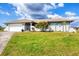 Charming single-story home with a two-car garage and well-manicured front yard at 3522 Fox Ter, Port Charlotte, FL 33981