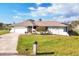 Charming single-story home with a well-manicured lawn and attached two-car garage, offering comfortable suburban living at 3522 Fox Ter, Port Charlotte, FL 33981