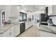 Bright kitchen features white cabinets, granite countertops, and modern stainless steel appliances at 3522 Fox Ter, Port Charlotte, FL 33981