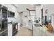 Well-lit kitchen with white cabinets, granite countertops, and modern stainless steel appliances at 3522 Fox Ter, Port Charlotte, FL 33981