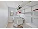 Laundry room features a washing machine, utility sink, and white shelving at 3522 Fox Ter, Port Charlotte, FL 33981