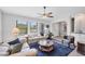 Spacious living room with comfortable sofas, a ceiling fan, and lots of natural light, creating a welcoming atmosphere at 3522 Fox Ter, Port Charlotte, FL 33981