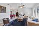 Cozy living room with comfortable seating, a ceiling fan, and abundant natural light from the large windows at 3522 Fox Ter, Port Charlotte, FL 33981