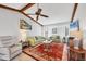 Comfortable living room with wooden beam ceiling, ceiling fan, and lots of seating at 3522 Fox Ter, Port Charlotte, FL 33981