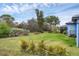 Spacious backyard with lush lawn and tropical landscaping at 4220 Cape Haze Dr, Placida, FL 33946