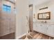 Bathroom with walk-in shower, white cabinets, and granite countertop at 4220 Cape Haze Dr, Placida, FL 33946