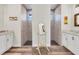 Elegant bathroom with double sinks, walk-in showers, and white cabinets at 4220 Cape Haze Dr, Placida, FL 33946