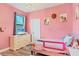 Pink bedroom with twin bed and dresser at 4220 Cape Haze Dr, Placida, FL 33946