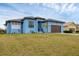 Beautiful light blue house with a brown garage door and nicely landscaped lawn at 4220 Cape Haze Dr, Placida, FL 33946