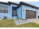 Inviting entryway to a light blue house with a stone walkway and landscaping at 4220 Cape Haze Dr, Placida, FL 33946