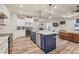 Open kitchen with large island, stainless steel appliances, and a view to the living room at 4220 Cape Haze Dr, Placida, FL 33946