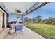 Outdoor patio with seating area and grill, overlooking backyard at 4220 Cape Haze Dr, Placida, FL 33946