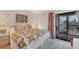 Main bedroom with king-size bed and sliding glass door to balcony at 4260 Placida Rd # 18C, Englewood, FL 34224