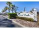 Forest Park community entrance sign with palm trees and landscaping at 4260 Placida Rd # 18C, Englewood, FL 34224