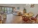 Light and airy dining area with wooden table and chairs at 4260 Placida Rd # 18C, Englewood, FL 34224