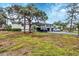 Condo building with covered parking and lush landscaping at 4260 Placida Rd # 18C, Englewood, FL 34224