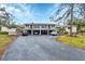 Condo building with covered parking and lush landscaping at 4260 Placida Rd # 18C, Englewood, FL 34224