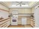 Galley kitchen with white appliances and ample cabinetry at 4260 Placida Rd # 18C, Englewood, FL 34224