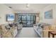 Living room with sofa, chairs, and access to a balcony at 4260 Placida Rd # 18C, Englewood, FL 34224