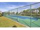 Community tennis court with chain-link fence at 4260 Placida Rd # 18C, Englewood, FL 34224