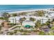 Aerial view of beachfront property, showcasing building and ocean at 5000 Gasparilla Rd # Dc307, Boca Grande, FL 33921