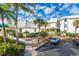 Condo building with palm trees, parking, and a walkway at 5000 Gasparilla Rd # Dc307, Boca Grande, FL 33921