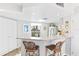 Kitchen with breakfast bar, white cabinets, and quartz countertops at 5000 Gasparilla Rd # Dc307, Boca Grande, FL 33921