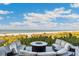 Oceanfront patio with fire pit and comfortable seating at 5000 Gasparilla Rd # Dc307, Boca Grande, FL 33921
