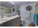 Bathroom with gray vanity, marble countertop, and walk-in shower at 5031 N Beach Rd # 112, Englewood, FL 34223