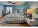 Bedroom with a seashell-themed bedspread and light blue walls at 5031 N Beach Rd # 112, Englewood, FL 34223