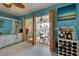 Bedroom with sliding doors to patio, light wood flooring, and ocean view at 5031 N Beach Rd # 112, Englewood, FL 34223