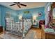 Bedroom with light blue walls, metal bed frame, and wood flooring at 5031 N Beach Rd # 112, Englewood, FL 34223