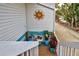 Small deck with potted plants and whimsical sun decoration at 5031 N Beach Rd # 112, Englewood, FL 34223