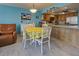 Charming dining area with white table and yellow tablecloth at 5031 N Beach Rd # 112, Englewood, FL 34223