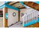 Quaint entryway with wooden stairs, beach decor, and seashells at 5031 N Beach Rd # 112, Englewood, FL 34223
