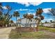 Front view of the house with palm trees and signage at 5031 N Beach Rd # 112, Englewood, FL 34223