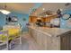 Bright kitchen with granite countertops, stainless steel appliances, and wood cabinets at 5031 N Beach Rd # 112, Englewood, FL 34223