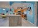 Open kitchen with granite island, stainless steel appliances, and light wood cabinets at 5031 N Beach Rd # 112, Englewood, FL 34223