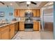 Kitchen with stainless steel appliances and light wood cabinets at 5031 N Beach Rd # 112, Englewood, FL 34223