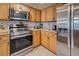Modern kitchen featuring stainless steel appliances and light wood cabinets at 5031 N Beach Rd # 112, Englewood, FL 34223