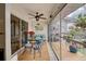 Screened lanai with seating area and access to the outside at 5031 N Beach Rd # 112, Englewood, FL 34223