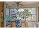 Covered lanai with table and chairs, offering outdoor dining space at 5031 N Beach Rd # 112, Englewood, FL 34223