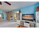 Living area with TV, leather seating, and a view of the kitchen at 5031 N Beach Rd # 112, Englewood, FL 34223