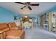 Open living room with leather couch, wood floors, and sliding glass doors at 5031 N Beach Rd # 112, Englewood, FL 34223