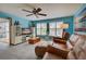 Relaxing living room with leather reclining chairs and a large TV at 5031 N Beach Rd # 112, Englewood, FL 34223