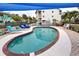 Inviting kidney-shaped pool with brick coping and shade structure at 5031 N Beach Rd # 112, Englewood, FL 34223