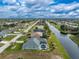 Aerial view of a canal-front home in a residential neighborhood at 60 White Marsh Ln, Rotonda West, FL 33947