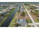Aerial view showcasing a canal side home and community at 60 White Marsh Ln, Rotonda West, FL 33947